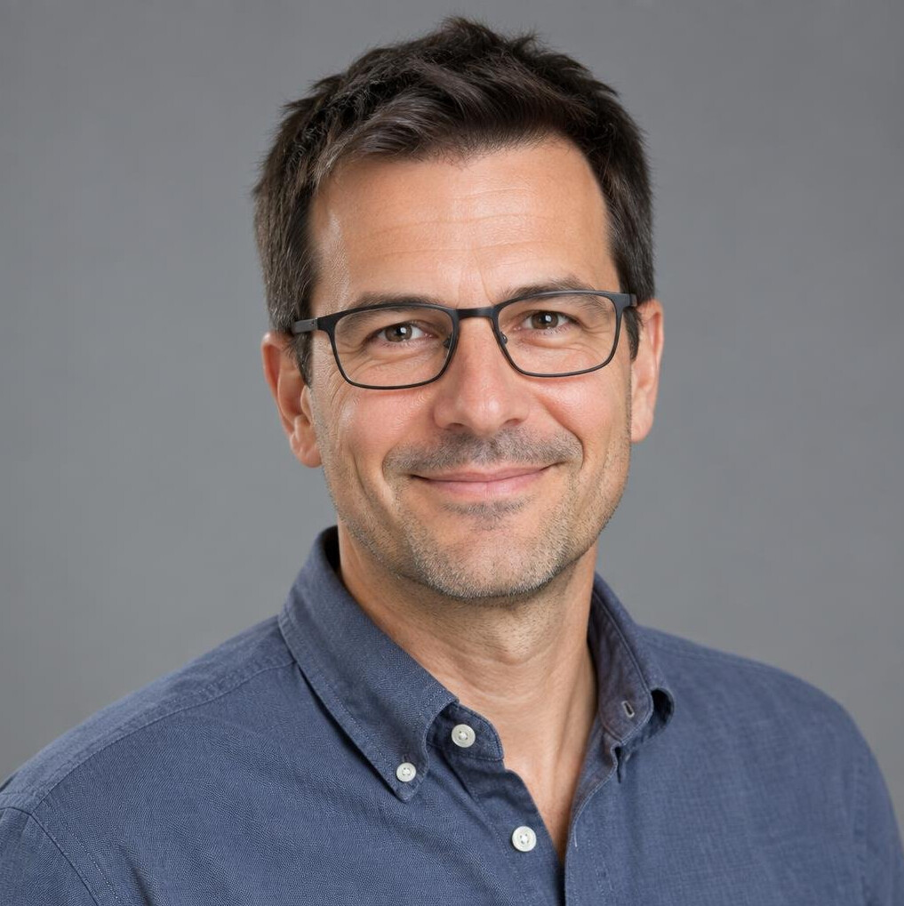 Studio portrait of a Swiss man data journalist with glasses